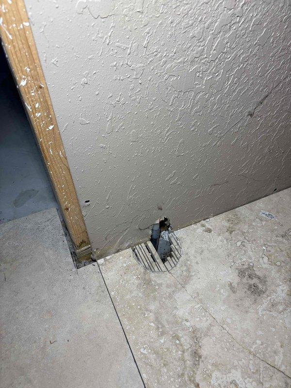 Resolved drainage issue by correcting improper PVC pipe installation in unfinished space. Repaired 90-degree elbow joint connection and addressed moisture concerns around floor penetration. Photos taken to document completed repairs for Ian's review.