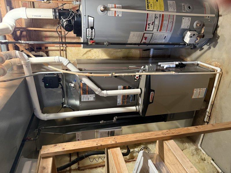 Successfully installed SLP99 90K furnace with S40 thermostat and 36B-71 cased coil in tight basement location with limited clearance. Installed new media cabinet with proper clearance from existing shelf structure and rerouted the 6" supply on top of the plenum. Completed 23ft of 2" cellular core PVC venting with four 90-degree elbows, replacing the existing exhaust pipe while maintaining proper connections through the block wall.