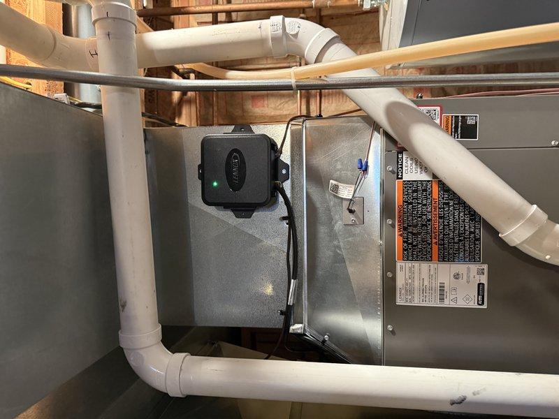 Successfully installed SLP99 90K furnace with S40 thermostat and 36B-71 cased coil in tight basement location with limited clearance. Installed new media cabinet with proper clearance from existing shelf structure and rerouted the 6" supply on top of the plenum. Completed 23ft of 2" cellular core PVC venting with four 90-degree elbows, replacing the existing exhaust pipe while maintaining proper connections through the block wall.