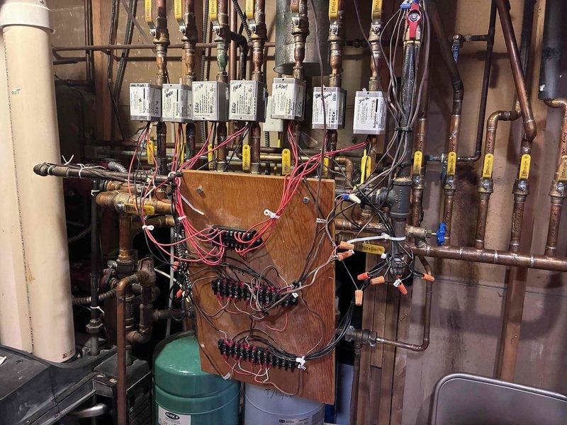 Responded to no heat complaint on Weil-McLain boiler showing error code E02. Diagnosed issue as plugged condensate drain tubing causing water leakage. Cleared obstruction from condensate line and verified proper system operation, restoring heat functionality.