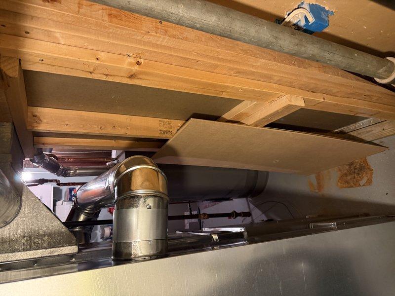 Completed installation of EL297V 70K Furnace and AA 600 air conditioning system, ensuring proper leveling and ductwork connections. Visual inspection confirmed correct mounting and alignment of all components in the basement/crawlspace area, with particular attention to secure ductwork joints and proper electrical connections.