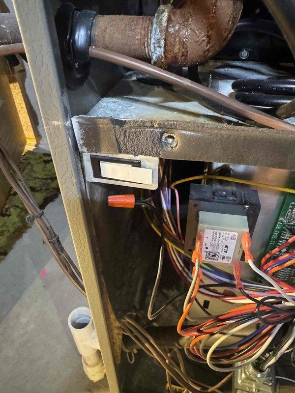 Diagnosed loss of power to furnace and air conditioning system. Identified defective blower door switch causing sizzling sound. Performed temporary repair by bypassing the faulty switch with wire nuts to restore power. Recommended replacement of door switch during next scheduled maintenance visit.