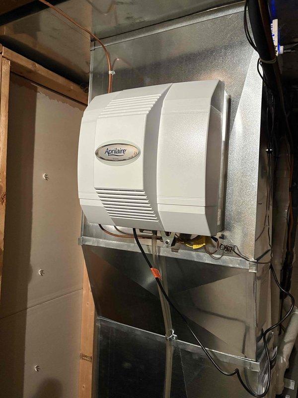 Responded to callback for whole-home humidifier issue. Inspected Aprilaire humidifier unit mounted on HVAC ductwork and evaluated Honeywell Home zoned control system (3 zones: 1st floor, 2nd floor, basement). Resolved connectivity issue between humidifier and control panel by repairing damaged orange signal wire and recalibrating system settings.