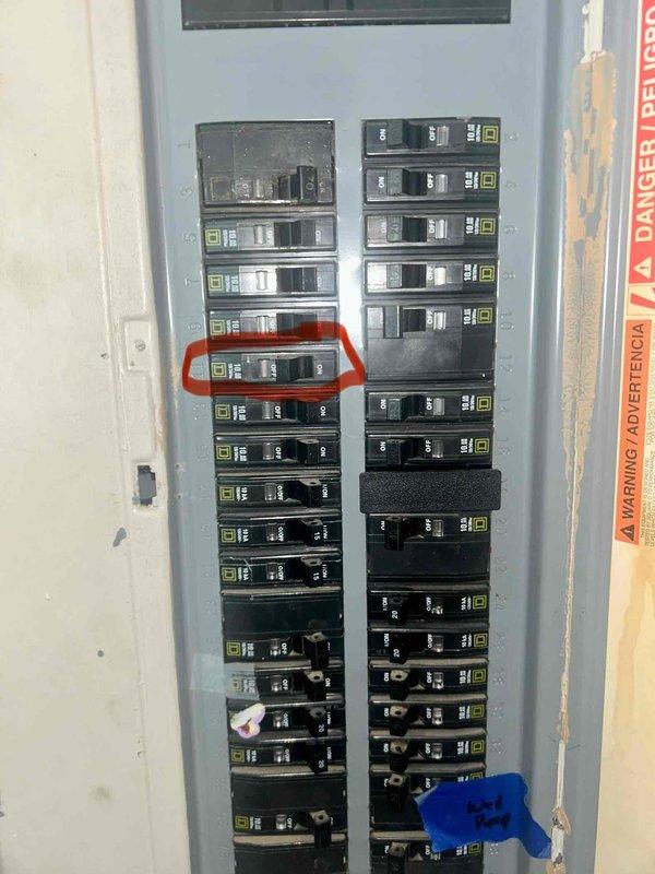 Performed inspection of electrical system after siding installation where contractor had removed and reinstalled light fixtures. Identified exterior wall fixture with continuous operation and inspected main electrical panel, noting code compliance issues. Marked problematic circuit breaker in panel for further attention and evaluated exterior connections affected by the recent siding work.