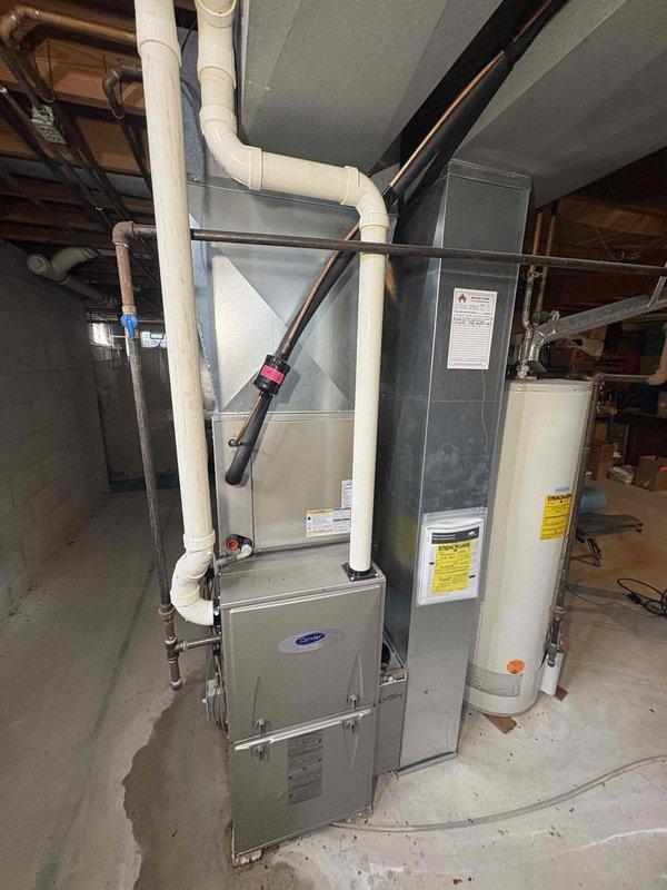 Responded to service call for IAQ issues where client reported valve not turning on with red indicator light visible on control panel. Upon inspection of Carrier furnace system with connected water heater, diagnosed control board malfunction preventing proper valve operation. Reset system control board, cleared error codes, and restored proper valve function, verifying normal condensate drainage and system operation before departure.