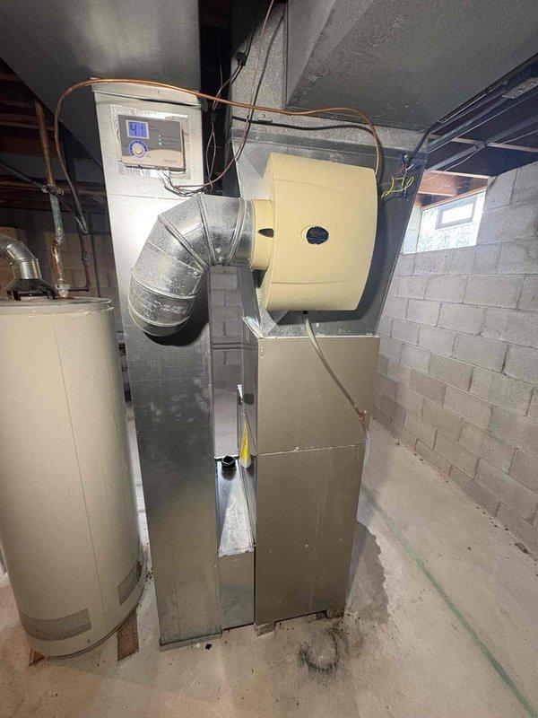 Responded to service call for IAQ issues where client reported valve not turning on with red indicator light visible on control panel. Upon inspection of Carrier furnace system with connected water heater, diagnosed control board malfunction preventing proper valve operation. Reset system control board, cleared error codes, and restored proper valve function, verifying normal condensate drainage and system operation before departure.