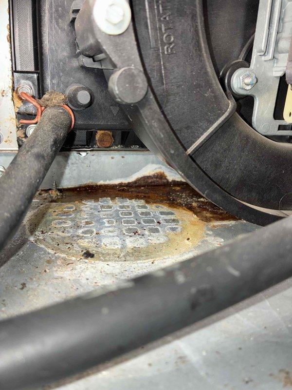 Replaced severely corroded collector box and gasket on unit due to extensive rust damage observed at the base assembly. Inspection of the system revealed significant moisture-related deterioration that had compromised the collector box integrity, requiring complete component replacement to restore proper operation.