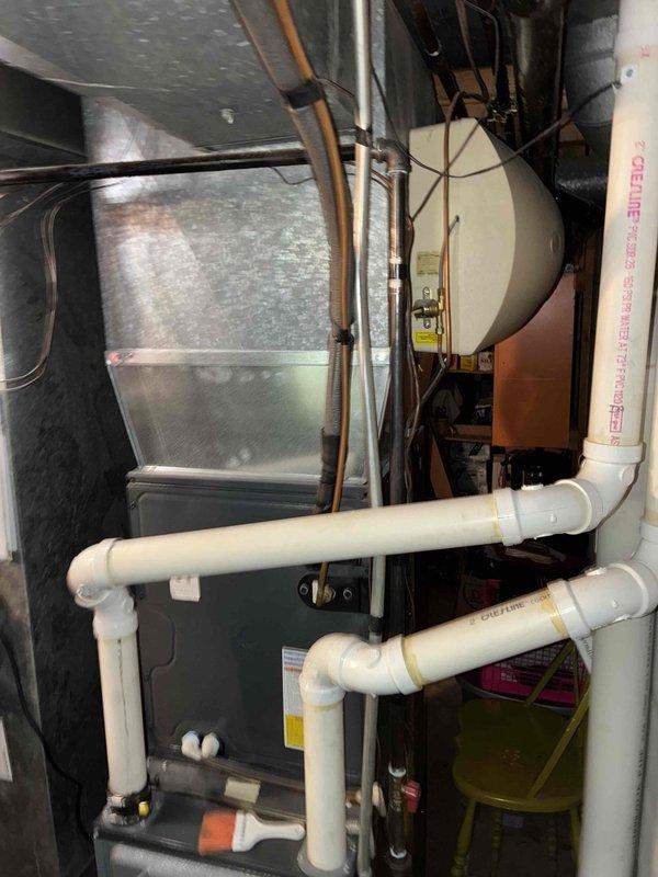 Responded to customer concern regarding ineffective AprilAire humidifier causing dry conditions and floor creaking. Inspected mechanical room HVAC system including furnace, water heater, and associated copper/PVC piping. Evaluated existing humidifier setup and connections to determine functionality issue.
