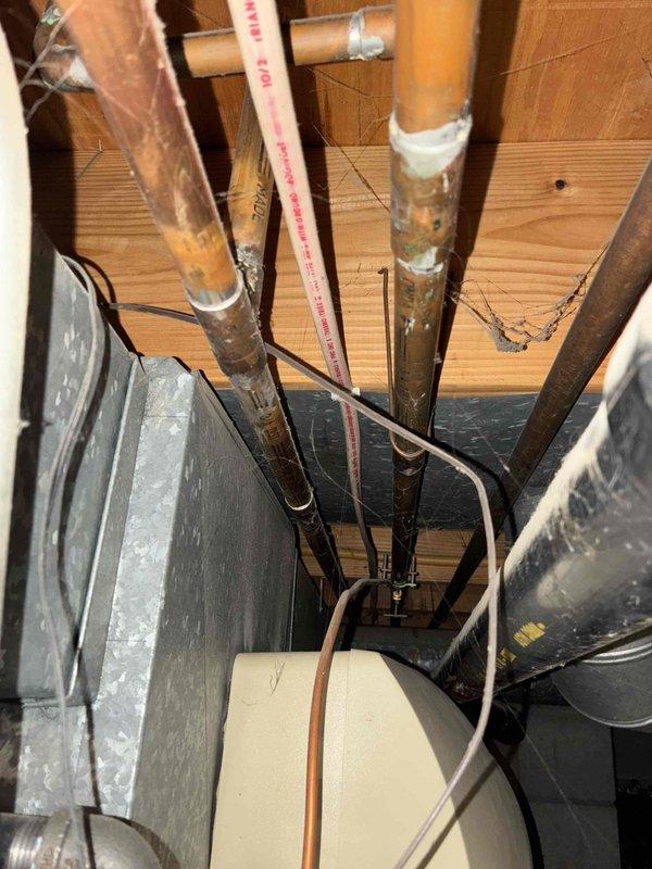 Responded to customer concern regarding ineffective AprilAire humidifier causing dry conditions and floor creaking. Inspected mechanical room HVAC system including furnace, water heater, and associated copper/PVC piping. Evaluated existing humidifier setup and connections to determine functionality issue.