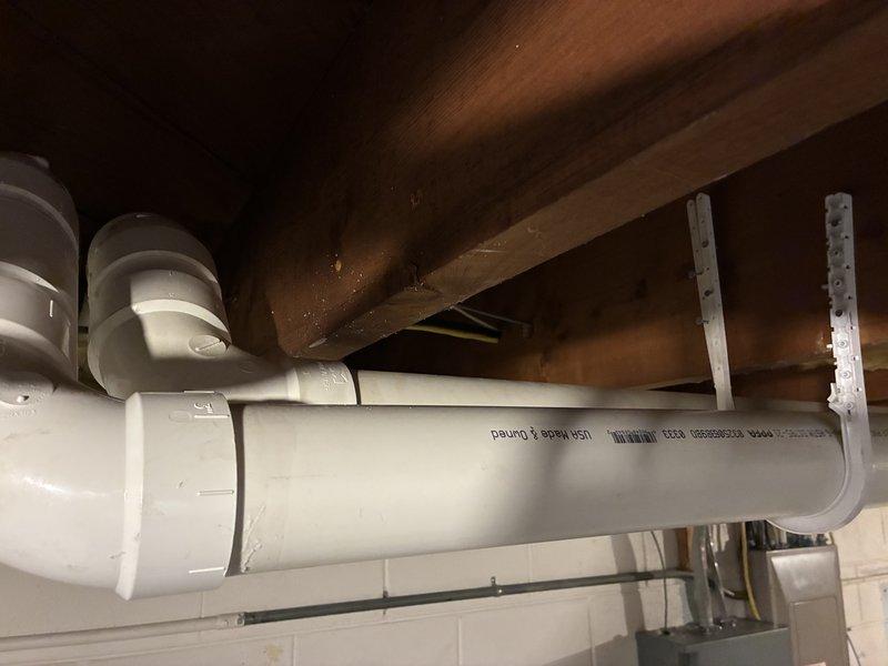 Inspected leaking boiler fitting in basement where copper pipe connection was failing. Identified sagging PVC exhaust line requiring additional support brackets. Explained WiFi connectivity options for the boiler system to customer and demonstrated proper setup procedure.