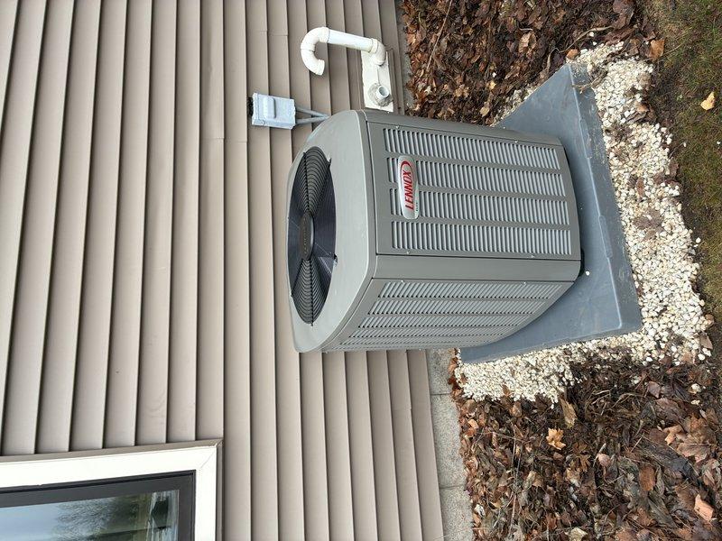 Completed full HVAC system installation, including Lennox EL297V 70K furnace, EL15KC1 2.5 ton AC, and 30/36B cased coil. Work included installing new T6 thermostat, relocating salt storage tank, and running new lineset and drop. Properly positioned outdoor unit on concrete pad with appropriate drainage stones for optimal airflow.