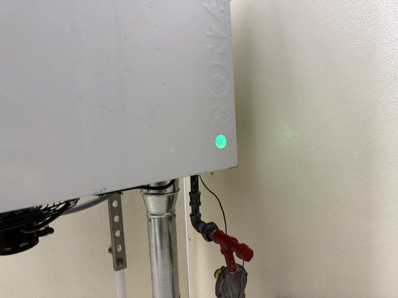 Successfully installed Reznor UDXC45 unit heater, hanging from ceiling in small building. Completed metal ventilation ductwork installation with proper mounting brackets and connected the system to existing gas lines with appropriate valves and pressure gauges. Verified proper system operation with controller functioning and indicator light showing normal operation.