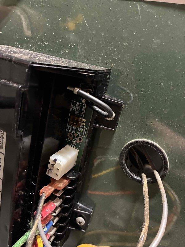 Conducted initial inspection of commercial boiler system in response to new maintenance agreement setup. Examined control circuitry including PCB connections and wiring harness inside access panel. Noted aged electrical assembly mounted on cinderblock wall with exposed wiring connections requiring attention. Documented system condition with photographs for baseline assessment. No service history available despite existing company identification sticker on unit.