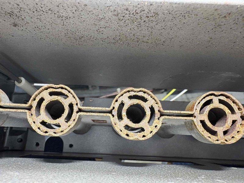 Completed 10-12 burner cleaning service to remove accumulated debris and performed replacement of failed inducer motor to restore proper system operation. Visual inspection revealed significant soot buildup on heat exchanger and deterioration of burner assembly components.