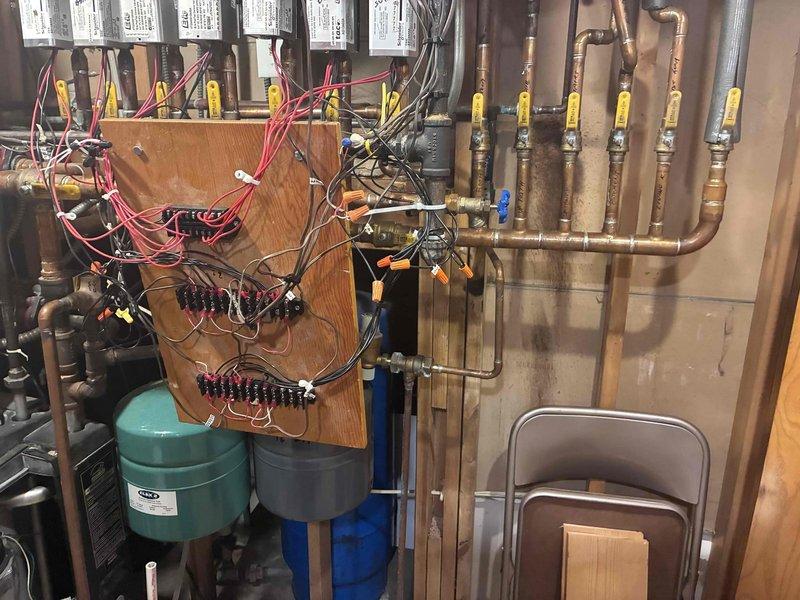 Completed installation of new zone control panels for 7 heating zones and 1 domestic hot water tank. Re-routed and extended wiring to properly position panels on wall behind and to the right of the boiler. Performed necessary rewiring of the older style boiler control system to integrate with new zone panels, ensuring proper functionality of all heating zones and domestic hot water control.