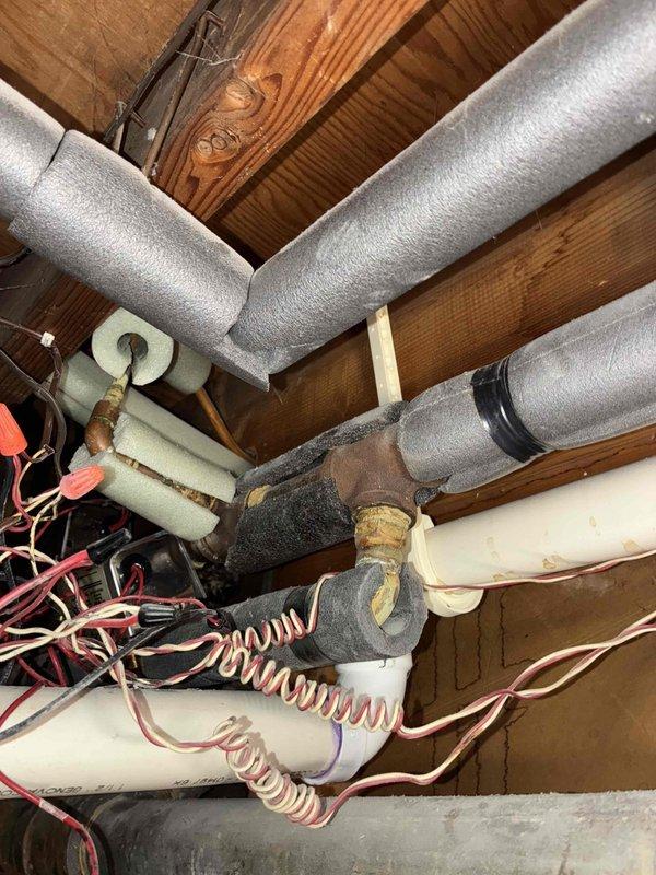 Responded to service call for new customer reporting leaking boiler zone valve. Upon inspection, identified corrosion at copper pipe junction with significant oxidation and green patina formation. Observed water staining on surrounding wooden structure, confirming active leak from zone valve assembly. Replaced defective zone valve and verified proper operation of system controls.