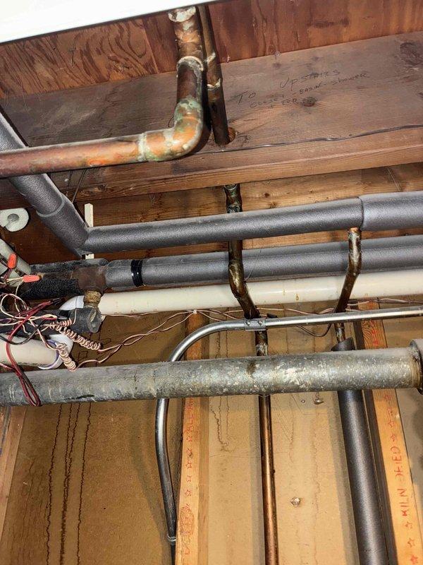 Responded to service call for new customer reporting leaking boiler zone valve. Upon inspection, identified corrosion at copper pipe junction with significant oxidation and green patina formation. Observed water staining on surrounding wooden structure, confirming active leak from zone valve assembly. Replaced defective zone valve and verified proper operation of system controls.