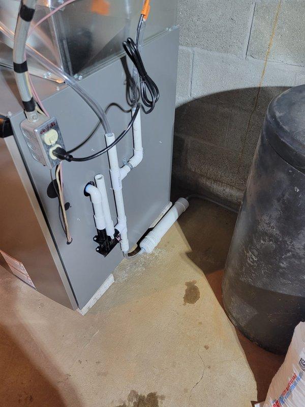 Successfully installed SLP99 90K Furnace with S40 Stat and AA 700 air cleaner in basement utility area. Reused existing 2" solid core venting and return drop with media cabinet, connected condensate drain to sump pump with required neutralizer, and replaced 1/2" gas valve with ball valve. Repositioned 10" round ductwork to accommodate new power humidifier installation on plenum.