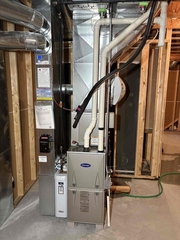 Performed annual maintenance on Carrier furnace per CCC Quality Plan agreement. Conducted comprehensive tune-up with filter replacement and gas pressure adjustment. System functioning properly after service. Also inspected leaking water heater and performed cleaning and maintenance on existing humidifier.