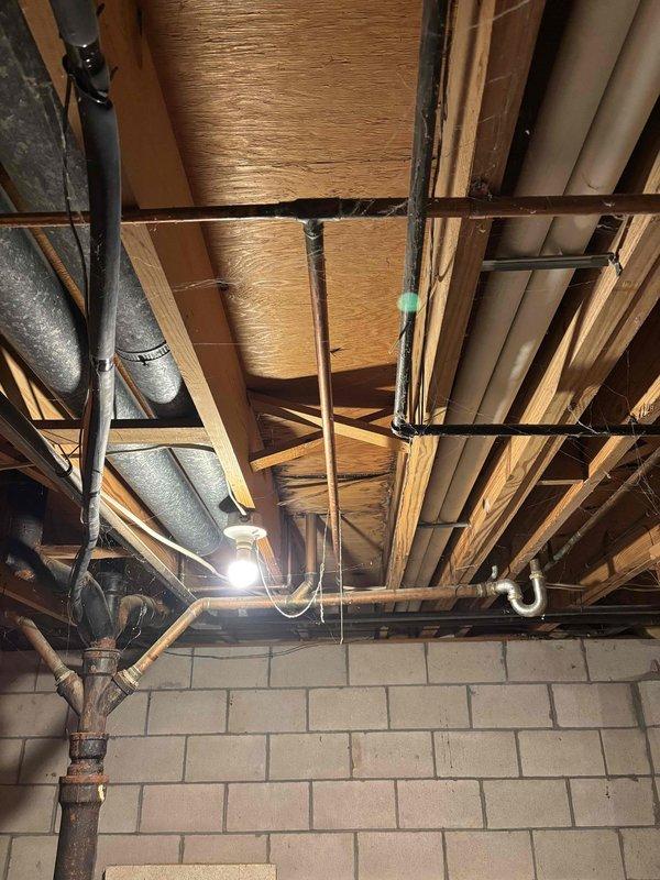 Performed annual CCC Quality Plan maintenance on furnace. Replaced 20X25X4 filter. Observed significant water damage and corrosion at base of water heater with visible leakage onto concrete floor. Noted exposed ceiling structure with various utility lines and ductwork in basement area.
