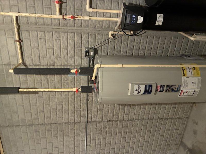 Replaced failed, leaking water heater with new 50-gallon electric Bradford White model. Completed full installation including proper pipe connections and insulation. Applied extended warranty sticker and documented model/serial numbers for warranty registration.