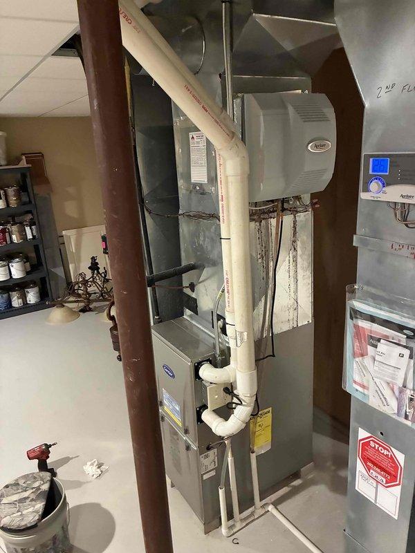 Responded to customer concern regarding small amount of water under furnace. Performed inspection of residential furnace system and connected humidifier in basement mechanical room. Checked operation of furnace, verified proper drainage of condensate, and confirmed all PVC venting and connections were secure and functioning correctly.