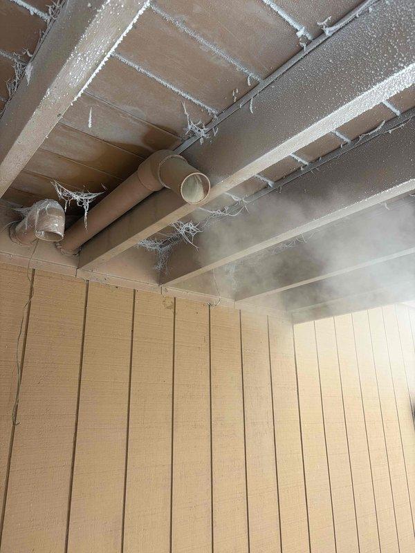 Responded to no heat call where customer reported a flashing 4-times error code after using fireplace. Diagnosed pressure switch failure due to negative pressure issues. Discovered significant frost accumulation on ceiling joists and PVC venting system. Restored heat functionality by replacing pressure switch and adjusting combustion air intake to compensate for fireplace-induced draft problems.