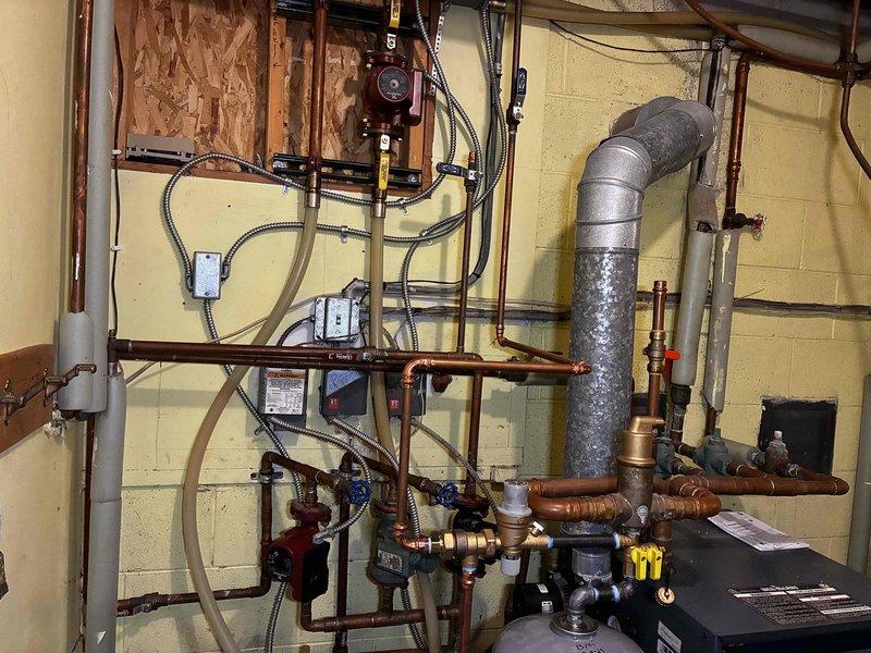 Diagnosed and corrected no-heat condition affecting second floor zone due to failed boiler circulator pump and malfunctioning flow check valve. Replaced circulator pump and rebuilt flow check valve to restore proper hydronic circulation throughout system, successfully resolving heating issues in back rooms and second floor.