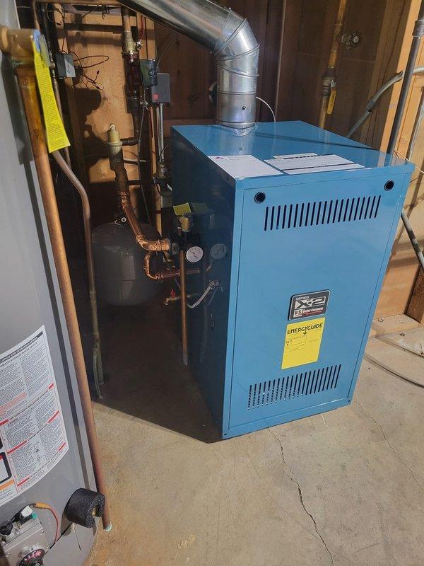 Completed installation of new X2 boiler system to replace failed existing unit. Installed complete vent pipe system with proper elbow joints and connected all required copper plumbing lines. System was tested and confirmed operational with all connections secure.