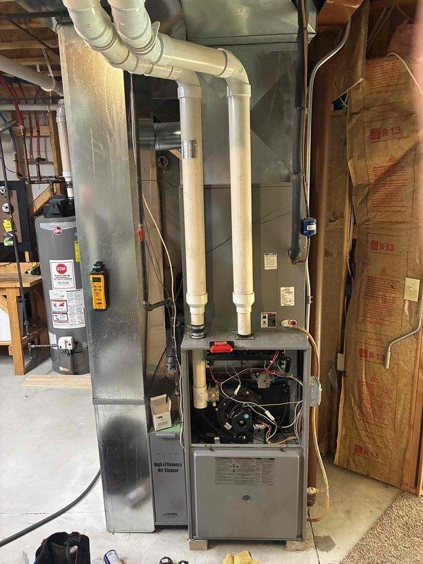 Responded to intermittent heat complaint where homeowner had previously replaced pressure switch. Diagnosed system in mechanical room with aging furnace showing open access panel. Inspected PVC exhaust venting and ductwork connections. Verified proper operation after homeowner's repair, confirmed system functioning correctly with no additional issues requiring immediate attention.