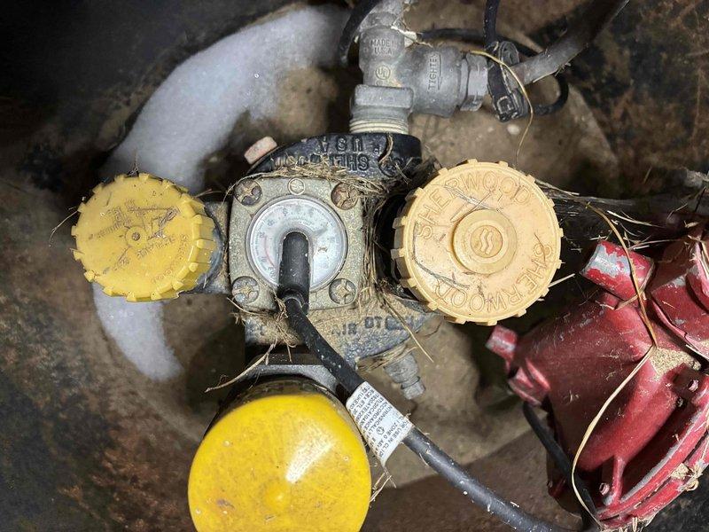 Responded to after-hours no heat service call for system less than 10 years old. Upon inspection, identified gas valve issues at the underground manifold. Cleared debris and cobwebs from Sherwood valve assembly, restored proper gas flow to unit, and verified normal heating operation before departure.