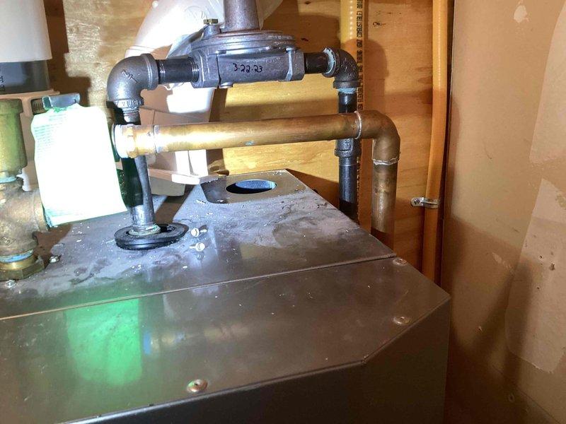 Responded to no heat/hot water call for 10+ year old system. Diagnosed blocked intake pipe from roof as root cause. Due to roof access limitations, modified system by removing piping from boiler to allow intake air from home interior, successfully restoring heat and hot water functionality.