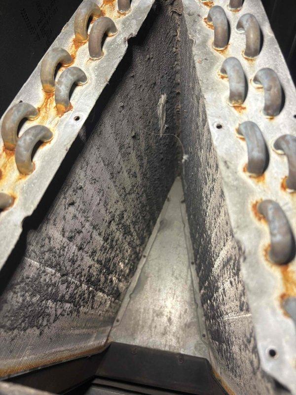 Responded to no heat call where unit was displaying 4-blink error code indicating limit switch activation. Discovered severely fouled evaporator coil with significant dirt accumulation and missing air filter despite recent tune-up. Performed thorough cleaning of A-coil to remove heavy buildup, installed proper filtration, and reset system which restored normal heating operation.