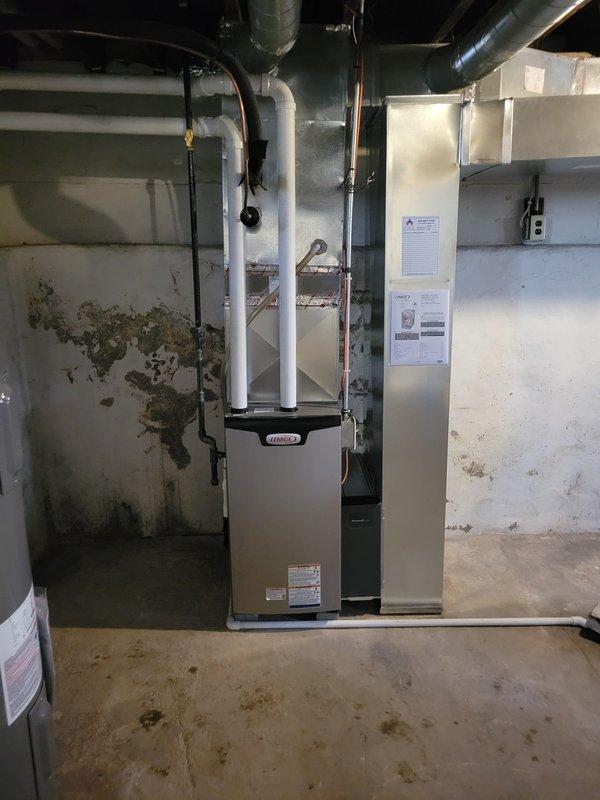 Completed installation of Lennox EL196E 70K BTU furnace with new media filter cabinet. Corrected improper PVC exhaust venting that was previously pitched backward and repositioned intake/exhaust configuration for proper operation. Replaced undersized return drop (24"x6") and added support bricks to furnace base. Verified gas connection and condensate drain functionality.