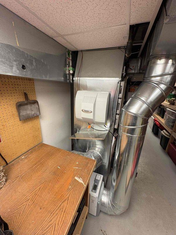 Responded to customer complaint about water leakage after extended absence. Inspected humidifier unit mounted on ductwork and identified disconnected drainage tubes in basement utility area. Observed significant moisture damage and potential mold growth on walls near the drainage system. Reconnected and secured all drainage lines to prevent future leakage.