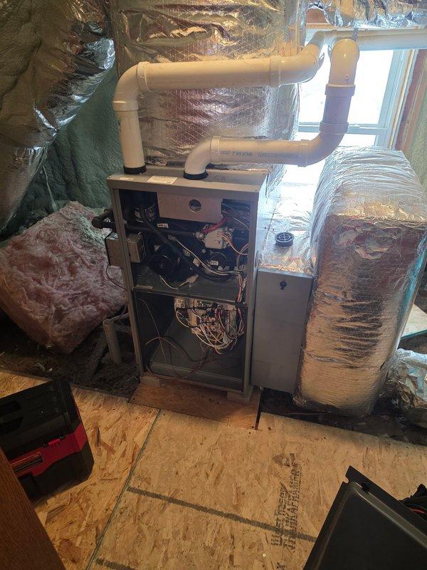 Responded to emergency no-heat call for 10+ year old system with intake blocked by ice due to improper installation by previous contractor. Performed corrective measures by extending flue pipe away from soffits to ensure proper venting and prevent exhaust recirculation. System now functioning correctly with exhaust properly directed away from the structure.