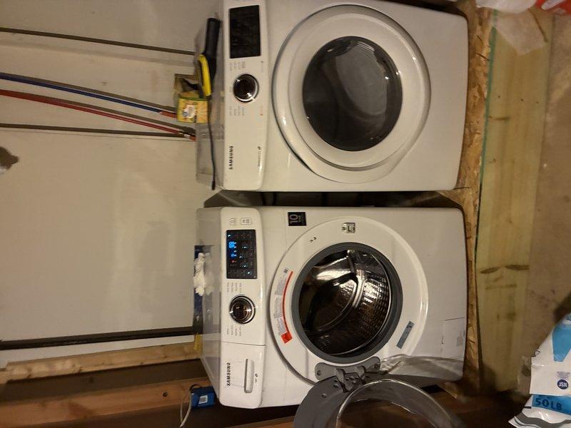 Conducted site visit to obtain measurements for laundry room installation. Inspected existing plumbing connections and utility lines in confined space. Examined stacked washer/dryer configuration and surrounding electrical connections to ensure proper placement and compatibility with current setup.