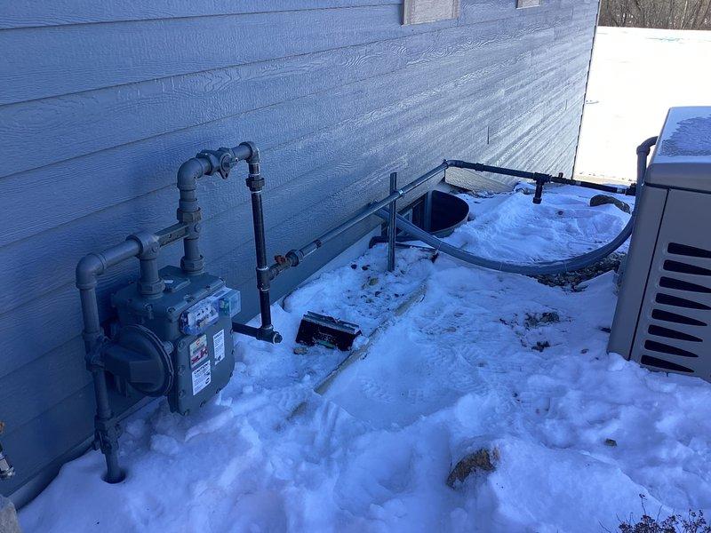 Completed gas re-piping service at residential property with outdoor meter. Successfully installed new gas line connections to service the exterior HVAC/generator unit located adjacent to the house. Work performed during winter conditions with all connections properly secured and tested.