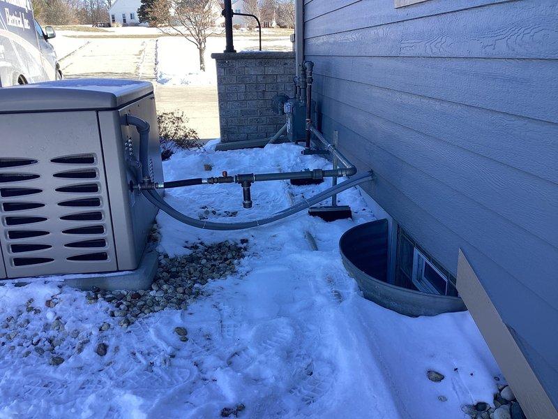 Completed gas re-piping service at residential property with outdoor meter. Successfully installed new gas line connections to service the exterior HVAC/generator unit located adjacent to the house. Work performed during winter conditions with all connections properly secured and tested.