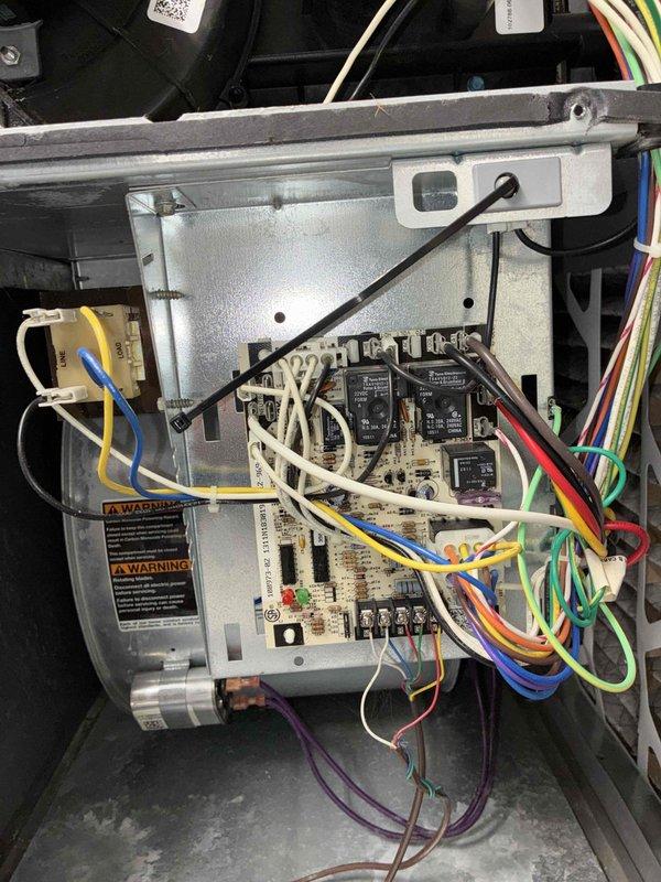 Responded to no heat service call with client complaint of burning smell from furnace. Upon inspection, found significant wear on blower motor with visible copper windings and signs of overheating. Discovered damaged control board with multiple relay failures causing system malfunction. Replaced both blower motor assembly and control board, restoring proper system function and eliminating burning odor.