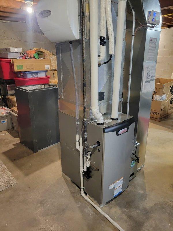 Successfully installed a Lennox EL297E 70K furnace with new PVC venting (25 ft per run) and replaced the return drop with necessary offset. Addressed electrical safety concerns by noting need for electrician to fix improper romex installation, and replaced old low voltage wiring with new as specified. Installed Healthy Climate Pure Air system and reused existing humidifier while replacing brass gas valve.