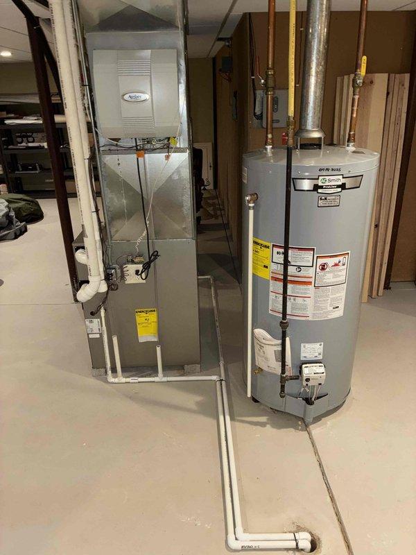 Performed comprehensive April Aire humidifier maintenance service including replacement of water panels and drain hoses, thorough cleaning of housing and insert tray, and operational testing to verify proper system function. Inspected basement HVAC setup including Carrier furnace unit and associated drainage system to ensure optimal humidification performance.