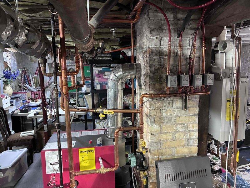 Responded to new customer with non-functional in-floor heating system that had been inoperative for years. Diagnosed multiple issues including significant air entrapment in the distribution system, two faulty zone thermostats, and improper boiler piping configuration. Performed system bleeding to remove air, restored proper system pressure, and documented necessary follow-up work to replace thermostats and reconfigure boiler piping for proper operation.