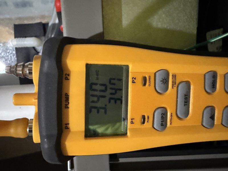 Completed installation of Lennox EL297V 70K BTU furnace with special accommodation using brick supports as noted. Conducted pressure testing with digital gauge, confirming readings of 344-349. All connections properly secured with PVC venting system installed against foundation wall.