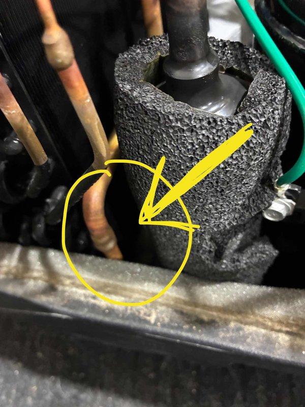 Responded to noise complaint from HVAC unit. Diagnosed issue as copper refrigerant line vibrating against case housing. Corrected by gently repositioning copper line away from contact point and applying foam insulation tape to eliminate vibration and prevent future contact.