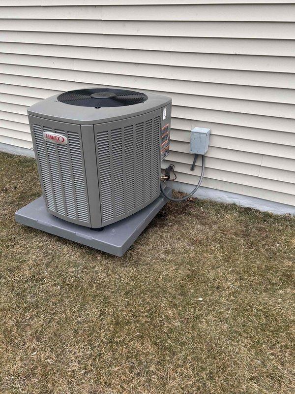 Completed installation of a 2.5 Ton Lennox EL15KC1 air conditioning system. Outdoor condenser unit was properly placed on concrete pad with electrical connections secured to exterior wall. Indoor components were installed in the basement mechanical room, including proper ductwork and PVC drainage configuration. Job was fully completed and documented with verification photos.