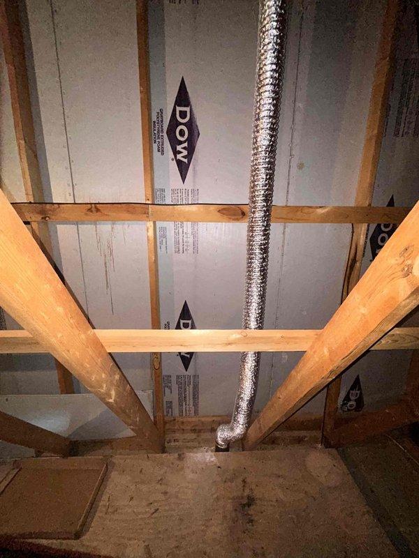 Successfully reconnected customer's bathroom exhaust fan in attic space by routing and securing flexible metal ductwork through existing structural framing. Proper ventilation was restored, resolving the issue previously identified by customer's roofer.
