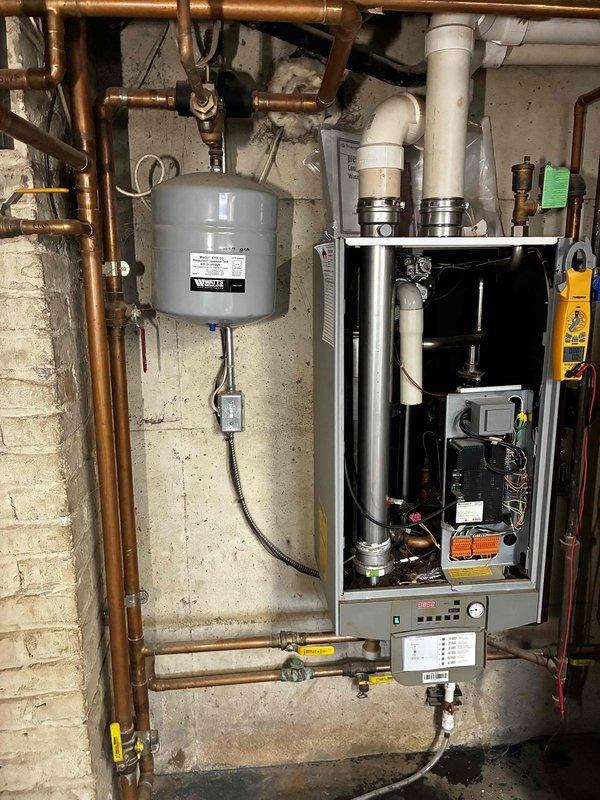Completed annual maintenance service on TriangleTube boiler system per manufacturer specifications under prepaid maintenance plan. Inspected all components including expansion tank, copper piping connections, and control panel functionality. Visual inspection confirmed system is operating properly with no issues identified.