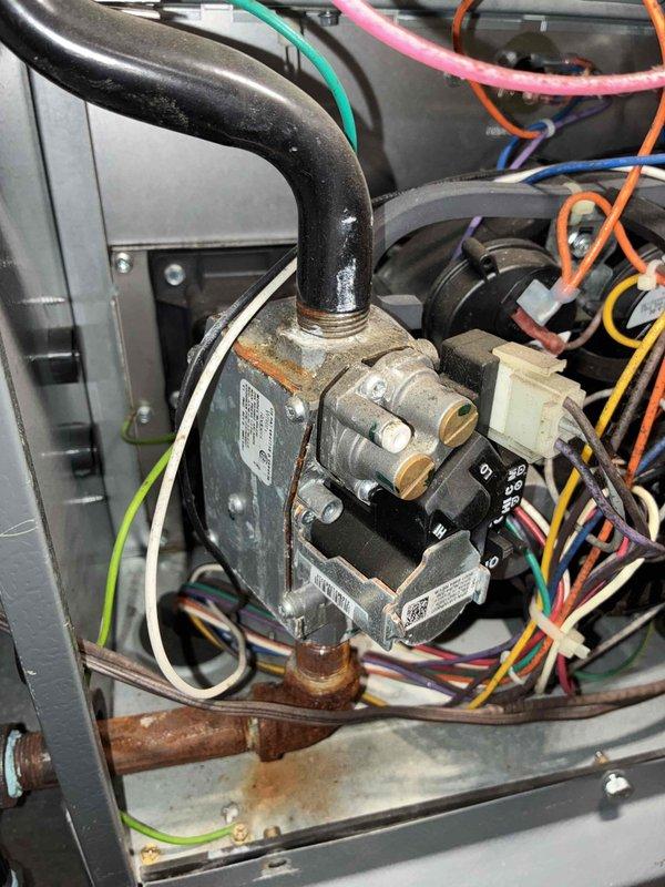 Replaced faulty gas valve on heating unit under parts warranty only (labor not covered due to lack of regular maintenance). System wiring and control board were inspected during service, with proper connections verified across all terminal points. Photographic documentation of the replacement and system components was taken for service records.