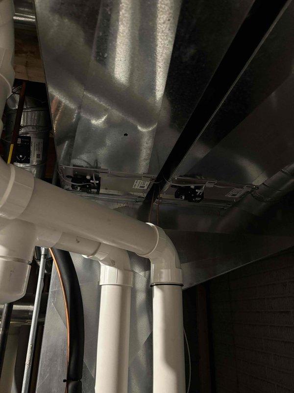 Responded to customer concern regarding an AprilAire 700 series humidifier leaking and low humidity levels. Upon inspection of the mechanical room, examined the PVC drainage system, copper supply line, and ductwork connections to the humidifier. Performed routine maintenance on the unit, clearing blockages in the drainage system that were causing water to back up. System now operating normally with proper humidity output and no leaks observed.